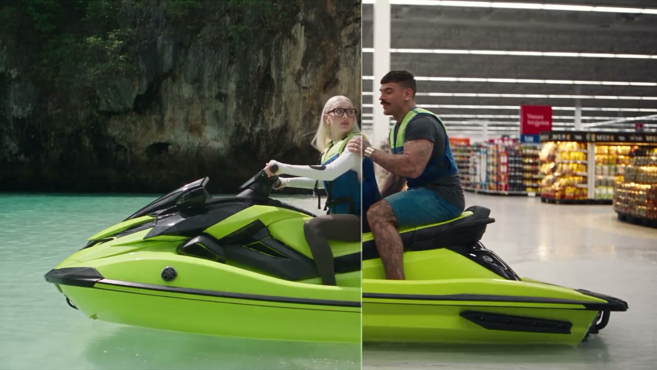 Two riders on a lime-green jet ski at the exact frame where a turquoise lagoon becomes a supermarket aisle